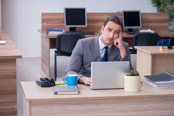 Young male employee working in the office