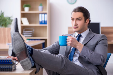 Young male employee working in the office