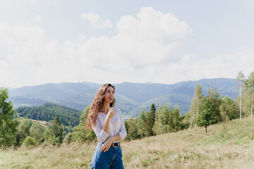 Fototapeta na wymiar Girl enjoying the mountain hills view. Feeling freedom in Karpathian mountains. Tourism travelling in Ukraine.