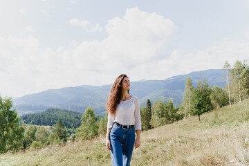 Fototapeta na wymiar Girl enjoying the mountain hills view. Feeling freedom in Karpathian mountains. Tourism travelling in Ukraine.