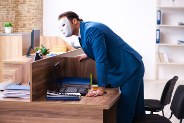 Young male employee wearing mask in the office