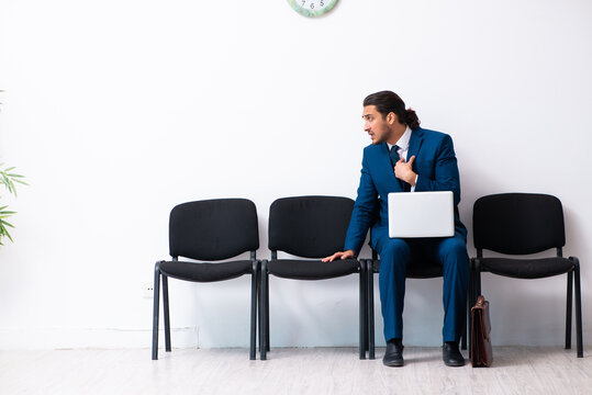 Young businessman waiting for an interview at hall