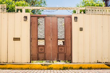 Door in a Wall Along a Sidewalk Leading into a Courtyard.