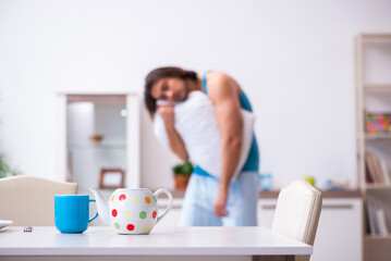 Young man waking up at home