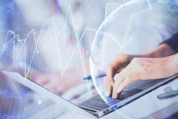 Double exposure of woman hands typing on computer and forex chart hologram drawing. Stock market invest concept.