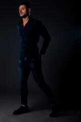 Fototapeta na wymiar Handsome stylish young caucasian male model dressed in dark blue shirt