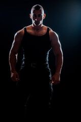 Fototapeta na wymiar Fitness muscular body on dark background