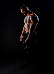 Fototapeta na wymiar Fitness muscular body on dark background