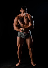 Young muscular guy in the studio, posing for the camera