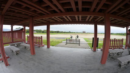inside the Nara palace area showing wooden structure, shrine and cycling trail
