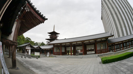 inside the Nara palace area showing wooden structure, shrine and cycling trail
