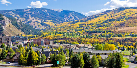 Avon Colorado Autumn scene with gold aspen trees dotting the mountainside - obrazy, fototapety, plakaty