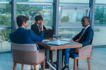 Multi-ethnic business people having discussion at conference table in office