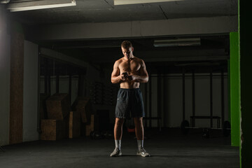 Fototapeta na wymiar Portrait of a shirtless athlete preparing for a workout.