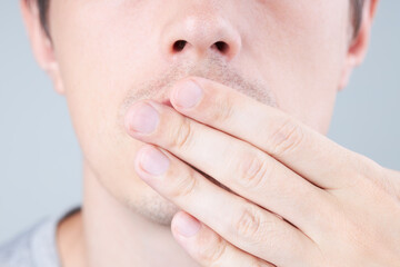 caucasian middle year male person showing secret or quiet gesturing. privacy and silent symbol concept. closeup