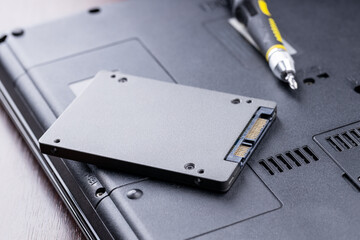 repairing and upgrading laptop computer. new solid state drive on a laptop. computer maintenance...