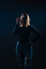 Silhouette picture of beautiful woman posing on black background