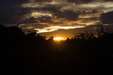 A rainy day sunset view with a part of sun and sunlight