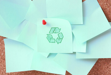 Cork board with notes, recycle sign