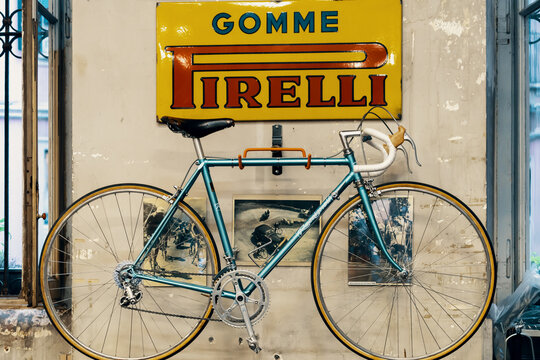 Logo Pirelli on the wall, bicycle in bicycle store. Pirelli is an Italian multinational company, focused on the consumer business - tyres for cars, motorcycles and bicycles. Milan, Italy - 28.09.2019