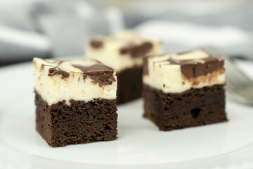 Cutting of homemade cheesecake swirl brownie or fudge