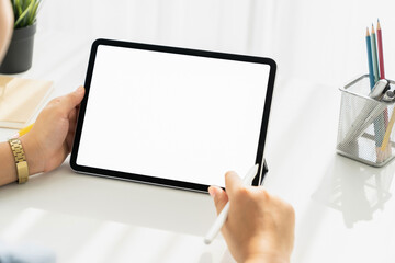 Woman hand holding digital tablet and the screen is blank. copy space for your advertising.