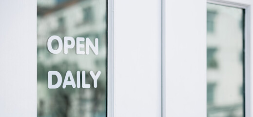Wording "open daily" sticker put on clear glass door symbol use for tell customer this shop is open daily