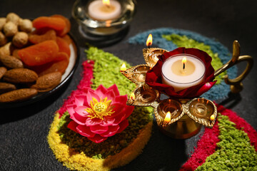 Festive composition with diya lamp for celebration of Divaly on dark background