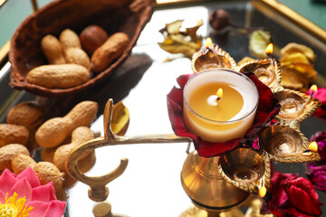 Tray with diya lamp and nuts for celebration of Divaly, closeup