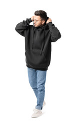 Naklejka premium Fashionable young man on white background
