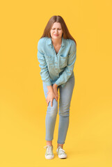 Woman with problem of limbs numbness on color background. Diabetes symptoms