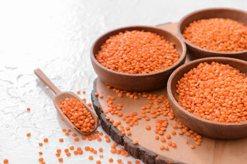 Bowls with raw lentils on table