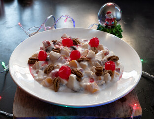 Christmas apple salad garnished with walnut and cherries