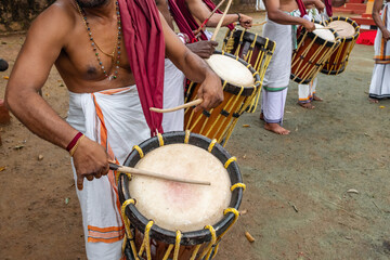 Indian men play traditional percussion drum Chenda in Kerala, India