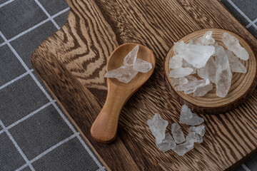Rock Sugar on wooden plate and spoon