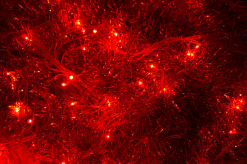 Shiny red tinsel with a garland. Beautiful festive background for the new year. copy space, top...