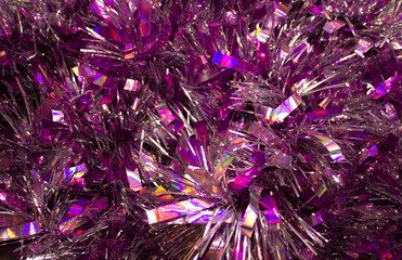 violet sparkling tinsel macro texture for a Christmas and New Year background. Shiny bright background with glitter closeup.