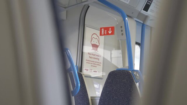 London, England, UK &ndash; November 07 2020: A &lsquo;wear a mask&rsquo; board sign hanging inside a train.