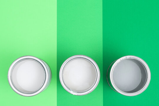 Open Paint Enamel Cans On Green Palette Samples.