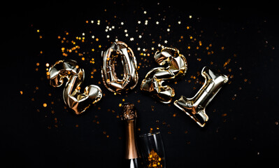 2021 golden foil balloons numbers, champagne, stars confetti, ribbons  and bokeh. Top horizontal...