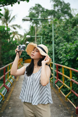Fashion portrait of young asian woman with vintage camera.