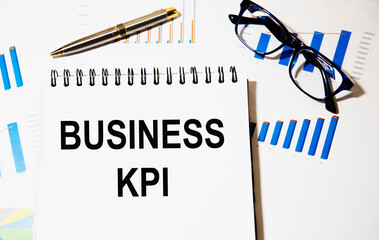 In the notebook the text business KPI, next to graphics, glasses.