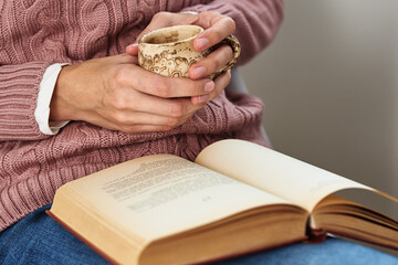 Woman sitting and reading a book. Relaxing concept