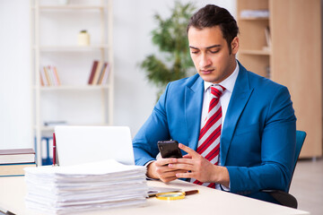 Fototapeta premium Young male employee working in the office