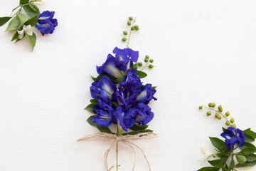 butterfly pea blue flowers of asia arrangement flat lay postcard style on background white wooden