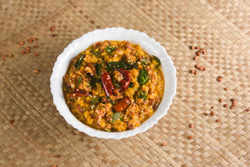 Kerala food for Onam festival special curry Erissery  , Pumpkin curry , Mathanga Elissery Onam sadya , sadhya palm mat background India. popular Sri Lankan food . South Indian spicy vegetable curry