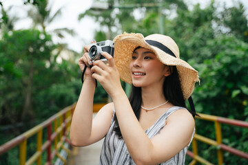 Fashion portrait of young asian woman with vintage camera.
