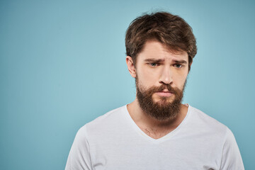 Fototapeta premium Bearded man emotions white t-shirt lifestyle gestures with hands blue backgrounds