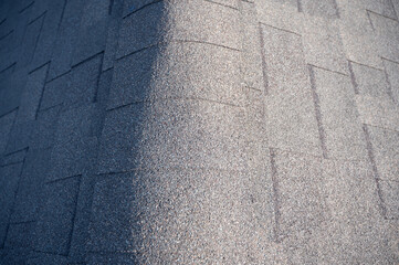 looking down the center of an asphalt shingle roof with ridge cap