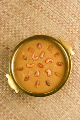 Parippu Payasam Pradhaman  or Moong Dal Kheer Indian sweet Kerala food for Onam festival special dessert Mithai for Onam sadya , sadhya in golden brass bowl background. Also popular Sri Lankan food . 